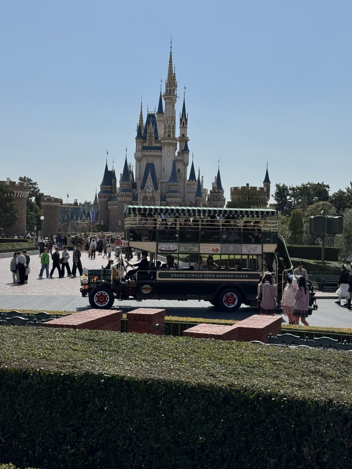Zamek Kopciuszka w Tokyo Disneyland z omnibusem Grand Circle Tour na pierwszym planie
