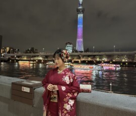 Kobieta w kimono i Tokyo Skytree nocą Kobieta ubrana w bordowe kimono przy nabrzeżu rzeki Sumida z Tokyo Skytree w tle